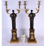 A LARGE PAIR OF EARLY 19TH CENTURY FRENCH EMPIRE BRONZE AND ORMOLU CANDLESTICKS modelled upon column