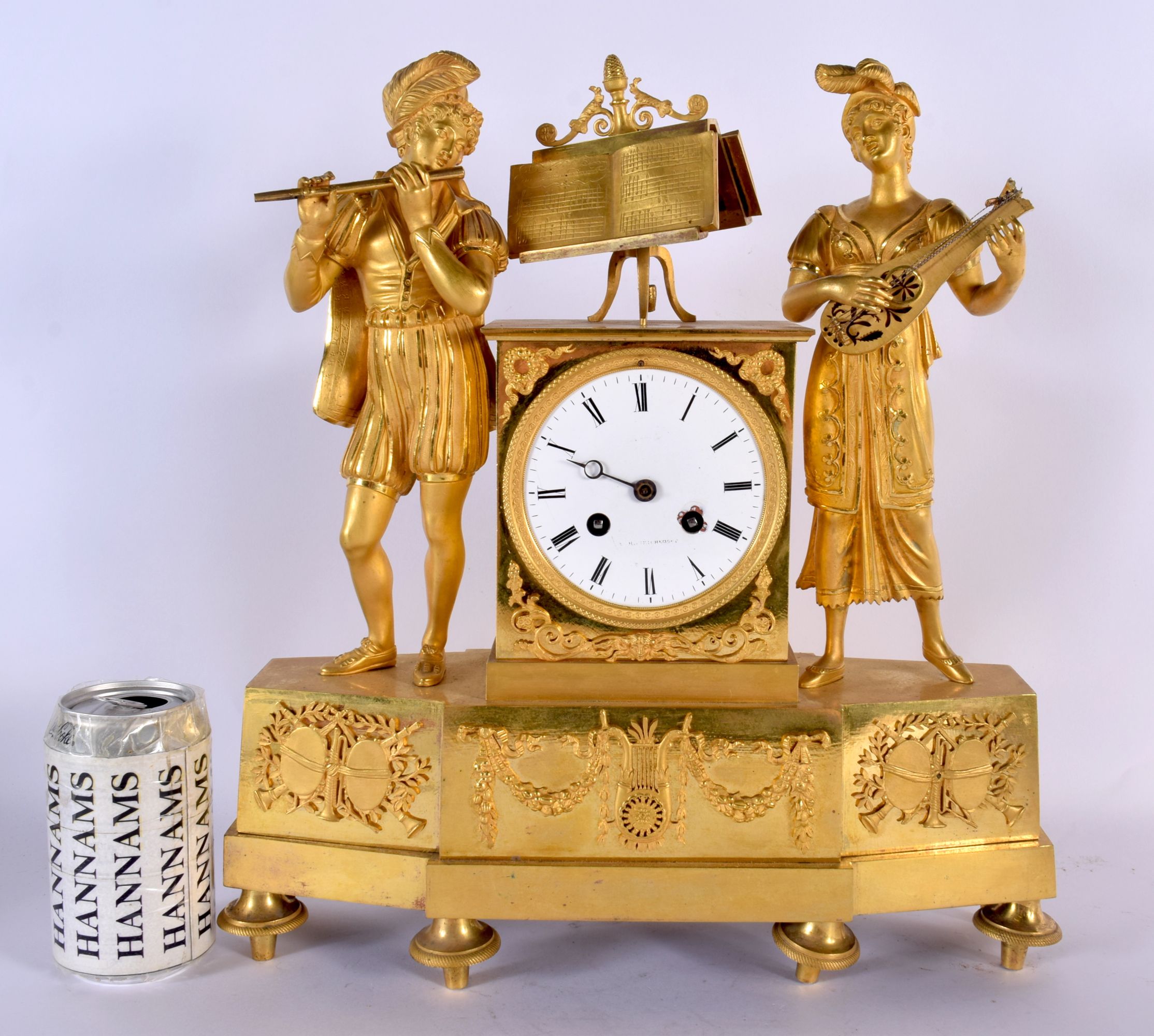 A LARGE EARLY 19TH CENTURY FRENCH GILT BRONZE EMPIRE MANTEL CLOCK formed as a figure and a female pl