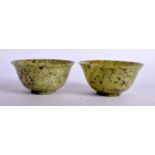A PAIR OF 20TH CENTURY CHINESE CARVED MOSS GREEN HARDSTONE BOWLS, 10 cm wide.