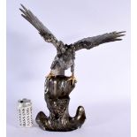 A LARGE LATE 19TH CENTURY JAPANESE MEIJI PERIOD BRONZE EAGLE modelled upon a naturalistic base. 50 c