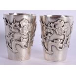 A PAIR OF 19TH CENTURY EXPORT SILVER BEAKERS decorated with birds. 54.9 grams. 4 cm x 3 cm.