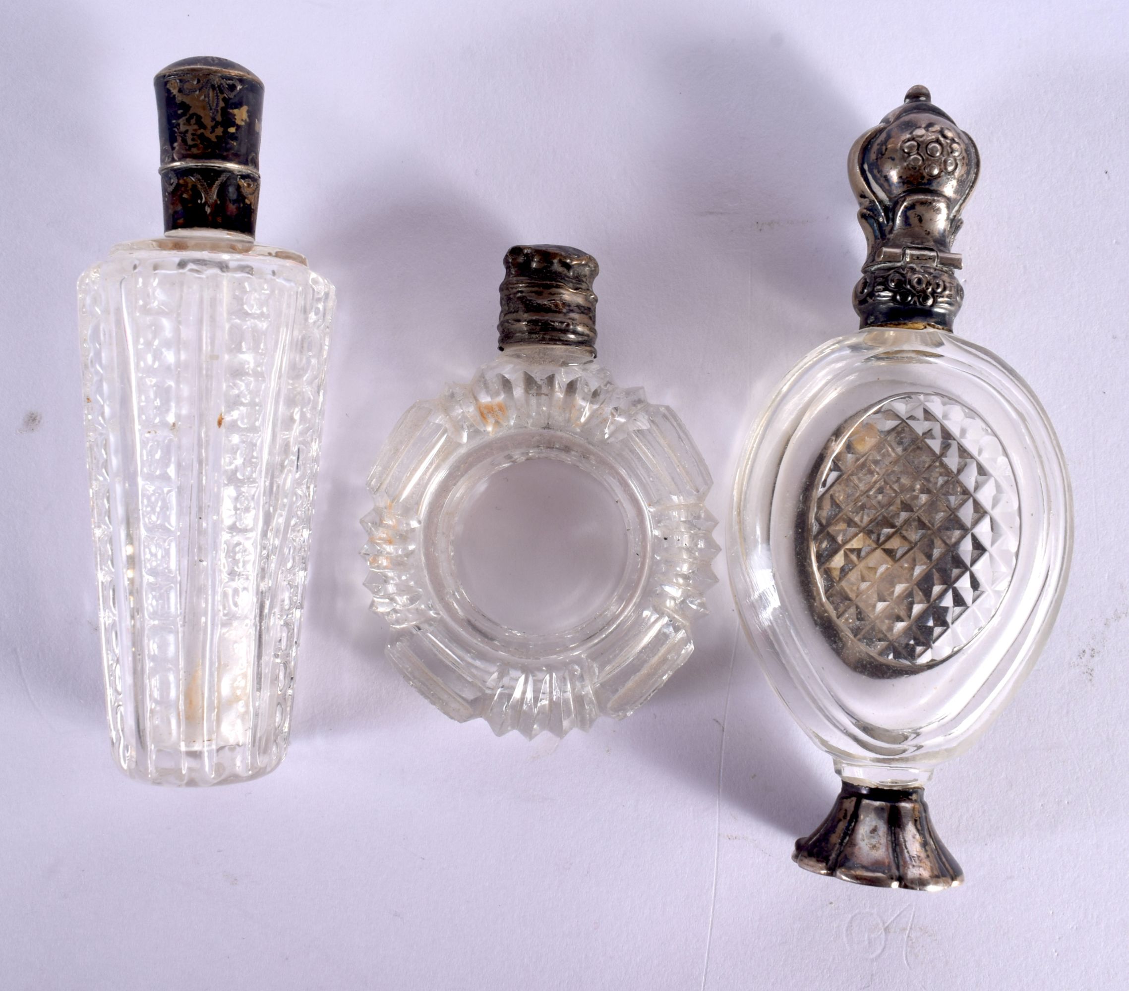 THREE ANTIQUE SILVER TOPPED CRYSTAL GLASS SCENT BOTTLES. Largest 10 cm x 4 cm. (3) - Image 2 of 3