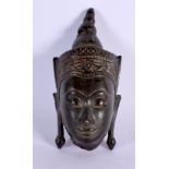 A 17TH/18TH CENTURY SOUTH EAST ASIAN CAMBODIAN BUDDHA HEAD decorated with vines. 12 cm x 4 cm.