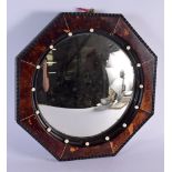 AN ART DECO FAUX TORTOISESHELL AND IVORINE OCTAGONAL MIRROR. 37 cm wide.