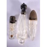 THREE ANTIQUE SILVER TOPPED CRYSTAL GLASS SCENT BOTTLES. Largest 10 cm x 4 cm. (3)