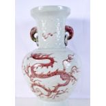 A large Chinese porcelain Celadon vase decorated in relief with a red underglaze dragon and elephan