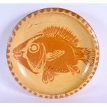 A STYLISH STUDIO POTTERY SLIP DECORATED POTTERY GUNARD FISH DISH. 31 cm diameter.