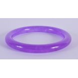 A CHINESE CARVED LAVENDER JADE BANGLE 20th Century. 7.5 cm diameter.