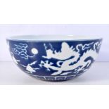 A Chinese porcelain sacrificial blue bowl decorated in relief with a dragon 12 x 27 cm.