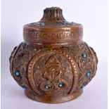 A 19TH CENTURY TIBETAN NEPALESE COPPER ALLOY JAR AND COVER decorated with repousse figures and inlai