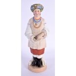 A RUSSIAN PORCELAIN FIGURE OF A STANDING FEMALE modelled wearing a floral wreath. 22 cm high.