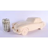 A CHARMING BRISTOL POTTERY MODEL OF A VINTAGE CAR by Ted Eric Wayman. 37 cm wide.