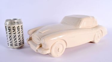 A CHARMING BRISTOL POTTERY MODEL OF A VINTAGE CAR by Ted Eric Wayman. 37 cm wide.
