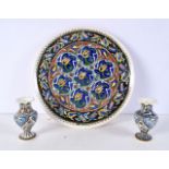 A middle Eastern Iznik type Faience plate together with a similar pair of vases largest 32cm Diamete
