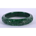 A CHINESE CARVED JADE BANGLE 20th Century. 7 cm diameter.