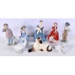 A collection of ceramic figures including a Beswick Cat, Nao, Royal Doulton largest 21 cm.(8).
