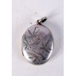 A VICTORIAN WHITE METAL LOCKET ENGRAVED WITH A BIRD AMONGST FOLIAGE. 3.1cm x 2.2cm, weight 5.6g
