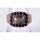 AN ANTIQUE YELLOW METAL GARNET AND HAIR MOURNING RING. N. 3.2 grams.