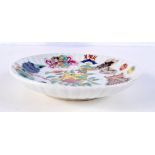 A Chinese porcelain dish decorated with calligraphy and figures 22 cm diameter.