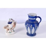 A Blue Jasper ware jug together with a small Staffordshire figure of a female on a goat 17 cm (2).