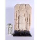 A SOUTH EAST ASIAN CAMBODIAN CARVED STONE TEMPLE PANEL depicting a standing deity. 34 cm x 17 cm.