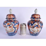 A PAIR OF 19TH CENTURY JAPANESE MEIJI PERIOD IMARI VASES AND COVERS. 28 cm high.