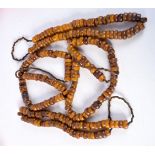 FOUR MIDDLE EASTERN AMBER TYPE PRAYER BEAD NECKLACES. 626 grams. Longest 86 cm. (4)