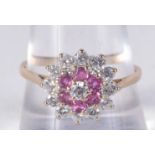 A 9CT GOLD DIAMOND AND RUBY CLUSTER RING. 2.4 grams. S.