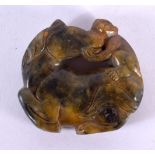 A 19TH CENTURY CHINESE CARVED JADE MONKEY AND HORSE ROUNDEL Qing. 5 cm wide.