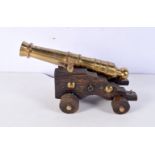 A heavy brass and wood desk cannon 13 x 23 cm.