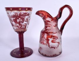A LARGE BOHEMIAN RUBY GLASS JUG together with a similar chalice Largest 25 cm high. (2)