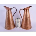 A PAIR OF ART NOUVEAU JOSEPH SANKEY & SON COPPER JUGS. 25.5 cm high.