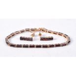 A GOLD PLATED GARNET BRACELET AND MATCHING EARRINGS. Stamped 925, Bracelet 18cm long, Earrings 1.6c