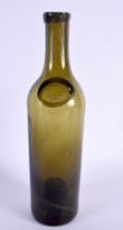 A GREEN GLASS WINE BOTTLE bearing initials to front SS. 31 cm high.