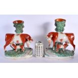 A LARGE PAIR OF 19TH CENTURY STAFFORDSHIRE FIGURES OF COWS modelled with calfs. 30 cm x 18 cm.