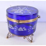 A blue glass lidded gasket with brass fittings and hand painted decoration 12 cm high.