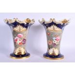 A PAIR OF MID 19TH CENTURY ENGLISH PORCELAIN FLUTED VASES painted with flowers upon a blue ground. 1
