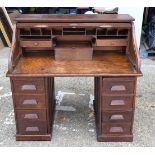 A VINTAGE ROLL TOP DESK with supporting drawers. 126 cm x 75 cm.