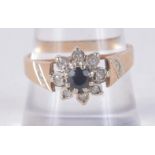 A 9CT GOLD DIAMOND AND SAPPHIRE CLSTER RING. 3.3 grams. O.