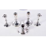 TWO PAIRS OF SILVER CANDLESTICKS and a silver chamberstick. 716 grams overall. Largest 10 cm x 8 cm.