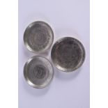 THREE CHINESE WHITE METAL COIN DISHES 20th Century. 330 grams. 9.25 cm diameter. (3)