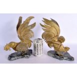 A PAIR OF EARLY 20TH CENTURY BRASS AND STONE COCK FIGHTING SCULPTURES. 30 cm high.