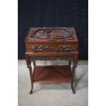 A Chinese carved hardwood box on a stand, the top carved with a Chinese rural scene with a dragon s