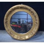 A large antique gilt wood and plaster mirror 80 cm diameter .