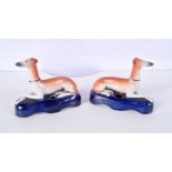 A pair of 19th Century Staffordshire greyhound pen holders largest 10 cm (2).