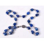 A SILVER MOUNTED LAPIS LAZULI NECKLACE. 57 grams. 64 cm long.