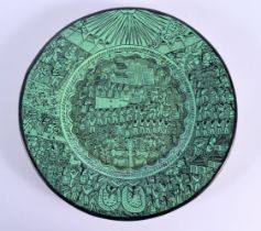 A LARGE SOUTH AMERICAN GREEN PAINTED POTTERY DISH decorated with figures in various pursuits. 31 cm