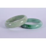 A PAIR OF CHINESE CARVED JADEITE BANGLES 20th Century. 6.5 cm diameter.