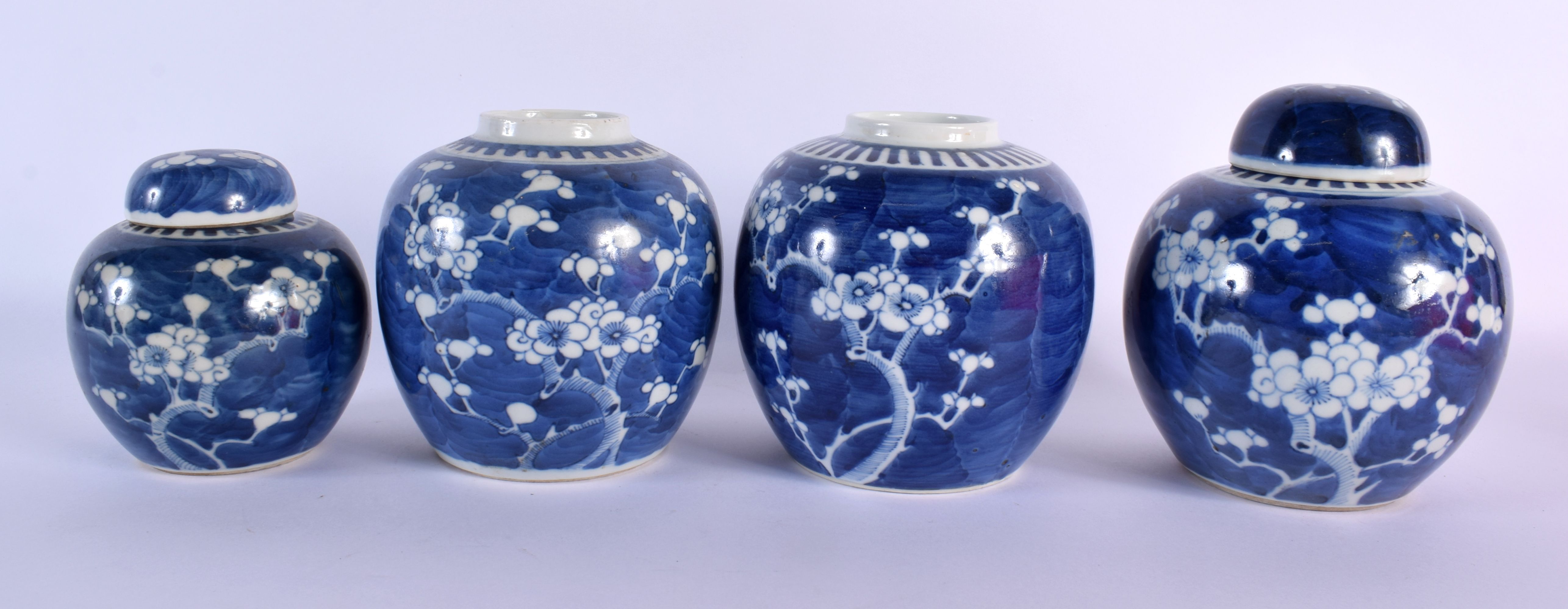 FOUR 19TH CENTURY CHINESE BLUE AND WHITE GINGER JARS Kangxi style. Largest 15 cm x 11 cm. (4)