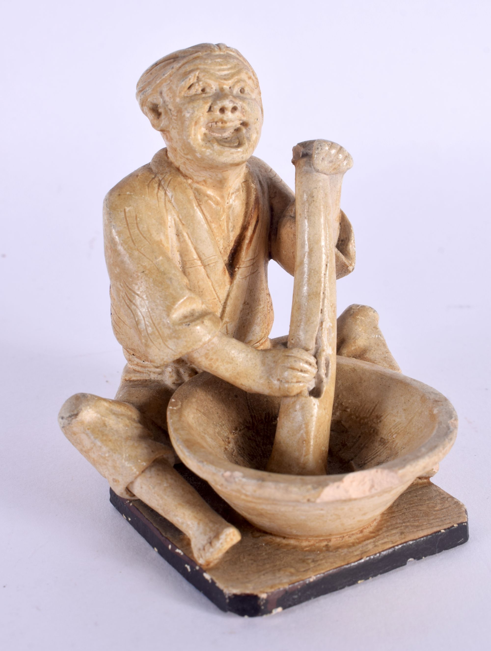 A LATE 19TH CENTURY JAPANESE MEIJI PERIOD POTTERY FIGURE OF A MALE modelled washing clothes. 7 cm x